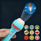 Children's toy flashlight with projection of a rocket and various other images on a dark background.